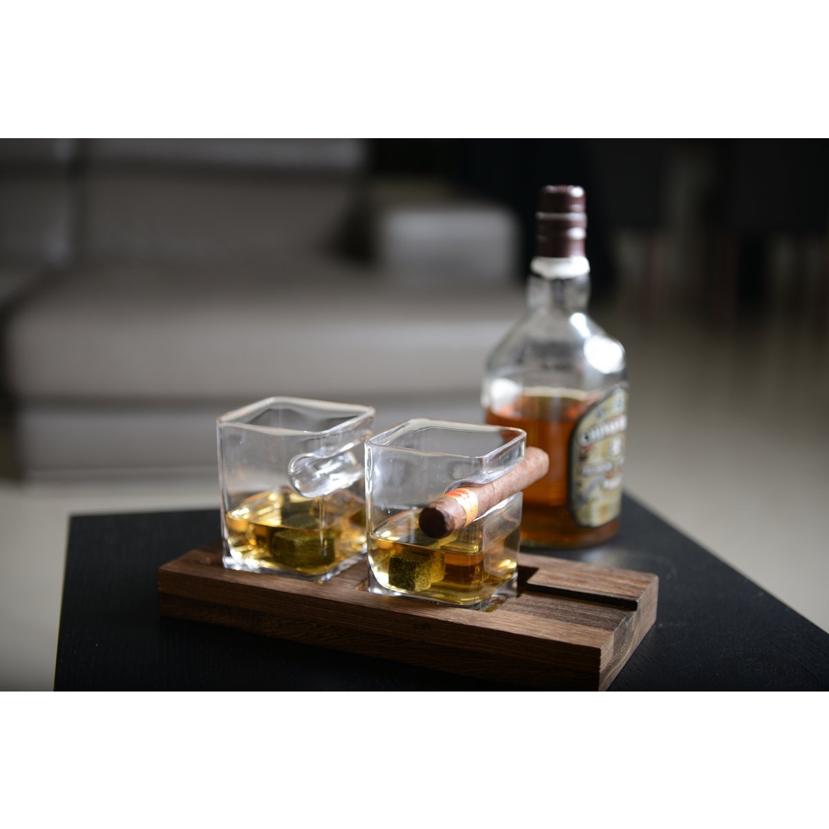 Glass whiskey set with wooden support and stone ice cubes