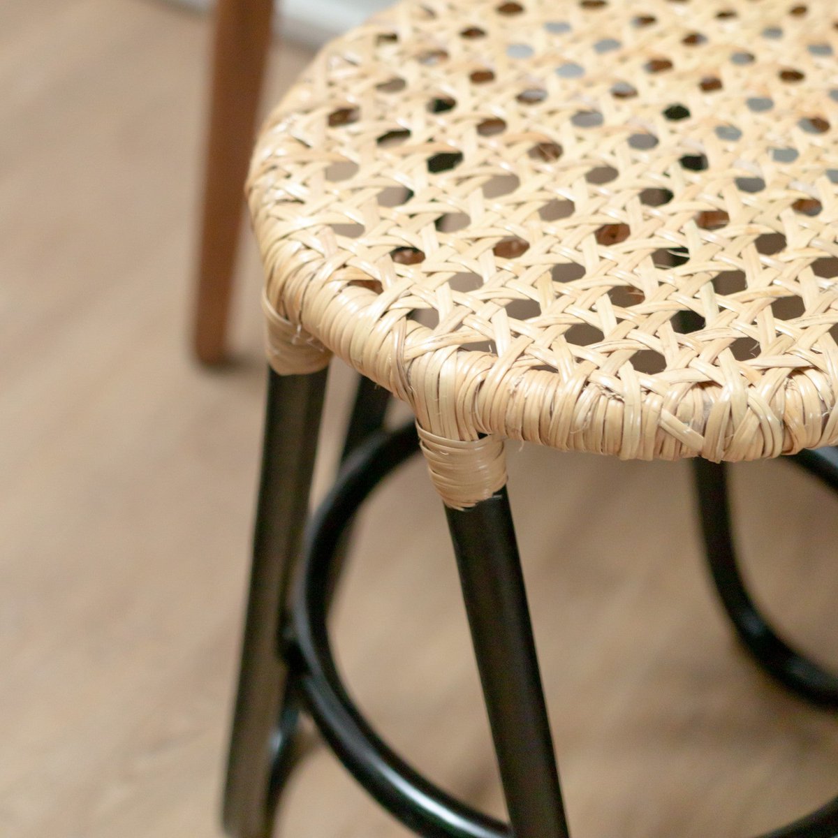 Rattan stool KOLAKA black Ø35 cm - three-legged woven seat